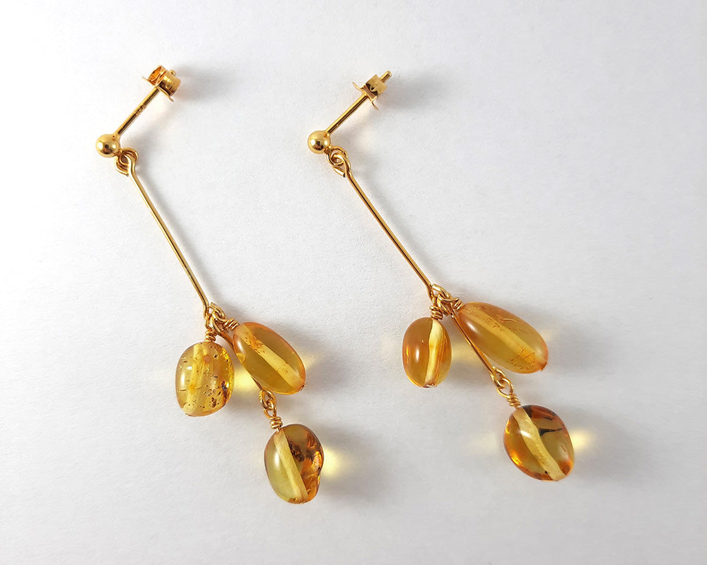 A pair of Himminglava earrings laying on a white background.