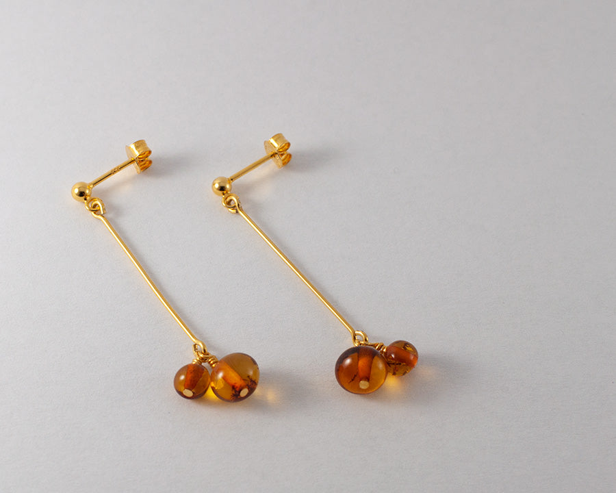 A pair of Duva goldplated earrings on white background.